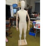 Vintage clothing display dummy standing on beechwood base with articulated wooden arms and hands. M