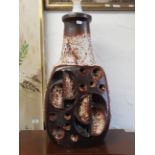 Large German Pottery table lamp which lights up the base and top. Measures 23 inches tall. See pho