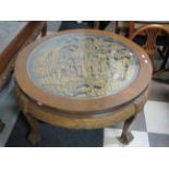 Circular low table raised on ball and claw feet with carved frieze around the perimiter. Centre tabl