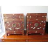 Matched pair of Chinoiserie cupboards decorated with birds and flowers. Each measures H:24 x W:20 x