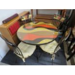 Metal constructed glass topped table with matching chairs, multi coloured table top and chair tops…