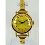 Timex Mechanical watch with Date window with expanding gold tone strap. Runs welll. See photos.