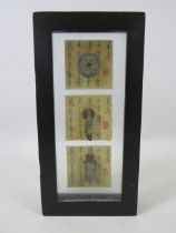 3 reproduction antique japanese coins in a display case.