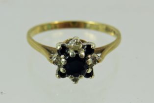 9ct Yellow gold ring set in a Diamond and Sapphire flower shape. Finger size 'O-5' 1.7g See photos