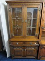 Old Charm style Dresser with Linen fold carved decoration to doors. Exposed hinges. Glazed bookshelf