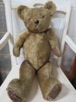 Vintage Teddy with stitched nose, Glass eyes. In fair condition, stitched repair to his left arm.