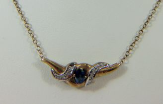 9ct Winged pendant set with a central Topaz with Diamond sides. Set on a 17 inch, 9ct Gold Chain.