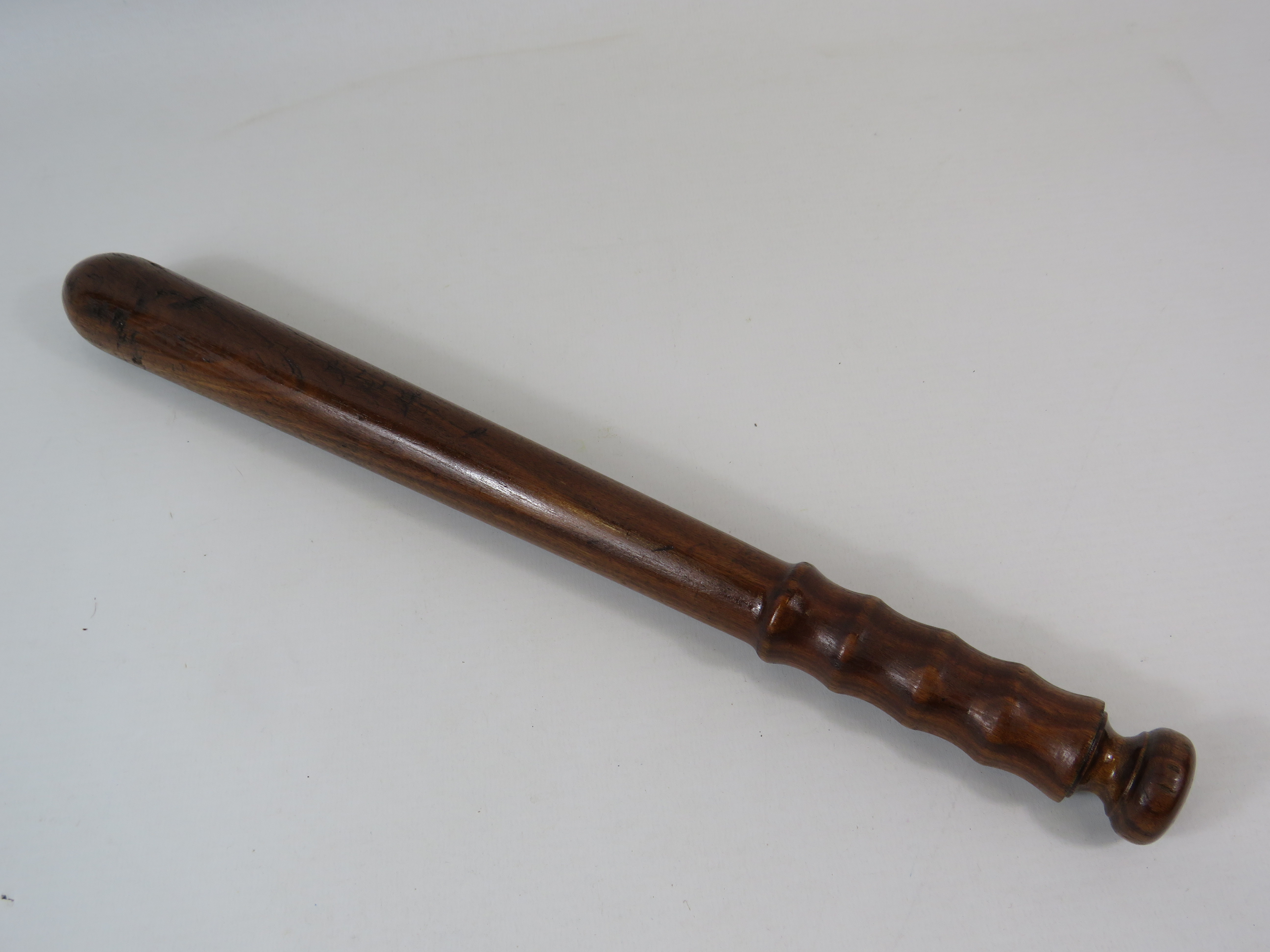 Military issue wooden truncheon.