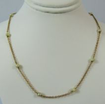 9ct Yellow Gold neck chain interspersed with 8 seed pearls. Total weight 2.5g