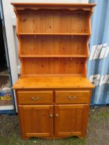 Pine Dresser with two cupboard doors and two drawers over, plate rack above. Measures H:69 x W:38 x