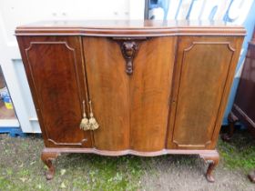 Late 19th Century mahogany cabinet with shaped centre door and two side cupboard drawers. Raised o