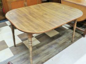 Extending oval topped table with four turned and tapered legs. Lovely grain to table top. Measures (