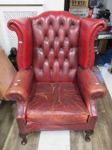 Vintage Red leather Chesterfield High back wing chair in comfortable shabby worn condition. Seat he