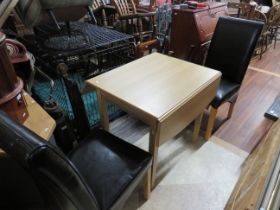 Nicely made Beech table with small fold out extending flaps. Comes with a pair of Leather upholster