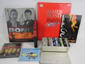 Assorted James Bond Items, Books to include an Ian Fleming Copy, Signed picture by Ken Wallace plus