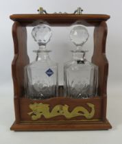 Vintage Tantalus with brass detail and a pair of national blood service decanters.