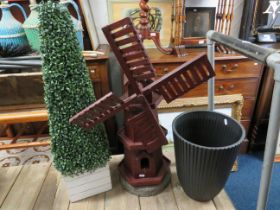 Wooden windmill set on concrete base (25 inches tall) together with an imitation shrub and a large p