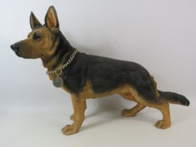 Large Resin sculpture of German Shepherd with stands 14 3/4 " tall and 21.5" long.