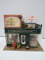 Paris coffee and cake shop model which lights up, approx 11.5" tall 13.5" long 9" deep.