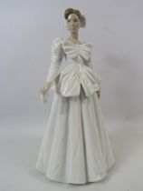 Lladro figurine of a lady in a white wedding dress with bows, approx 11" tall.