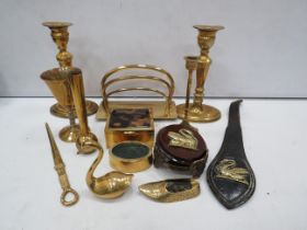 Selection of brass items including a letter rack, cigarette box, candle sticks etc.