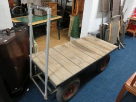 Well made four wheel trolley with tubular steel frame and timbered deck. Four pneumatic tyres, tubul