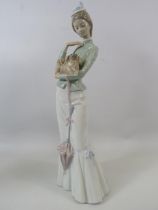 Large Lladro figurine of a lady with a dog, approx 14.5" tall comes with box.