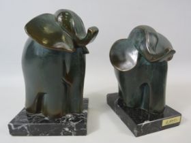 Two S.A PAOR abstract bronze elephant sculptures standing on marble bases. The tallest measures 7".