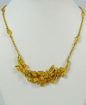 24ct Saudi Gold 16 inch Necklace with articulated pendant which features flowers and a butterfly, a