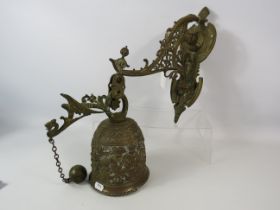 Large out door brass bell with cherub detail.