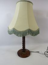 Twisted wooden table lamp with bird decoration to the base.