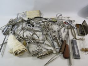 Large selection of vintage metal medical instruments.