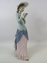 Large Lladro figurine of a lady reading, approx 14.5" tall comes with box.