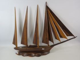 Large solid wood boat sculpture which measures 27" long and 22" tall.