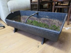 Victorian era cast iron animal feeder trough with centre strap/handle, bracket feet. Has been used a