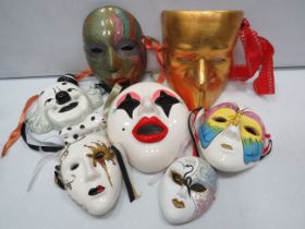 Various ceramic clown and face wall plaques.