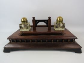 Antique wooden desk set with glass and brass ink wells and pen rest. 7" high, 16.5" wide & 12"