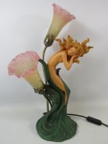 Art Nouveau style figural table lamp with glass tulip shades.