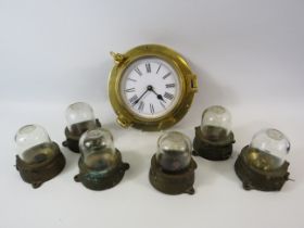 Quartz brass ships clock and 6 vintage light fittings with glass domes.