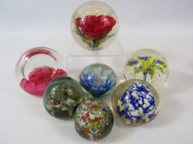 6 Art glass paperweights and one Haford Grange paperweight.