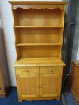 Pine Dresser with two cupboard doors and two drawers over, plate rack above. Measures H:71 x W:36 x