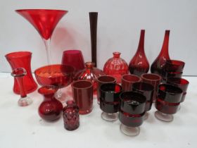Large selection of red art glass items.