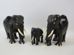 3 Wooden Ebony carved elephants. The tallest measures approx 5".