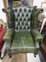 Vintage Green leather Chesterfield High back wing chair in comfortable shabby worn condition. Seat