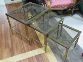 Gilt metal and glass occasional table trio. The largest measures H:18 x W:18 x D:22 Inches. See pho