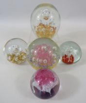 5 Various glass paperweights.