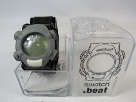 Mens Swatch beat wristwatch comes with original box but requires a new battery.