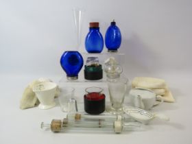 Selection of vintage medical bottles, measures, syringes etc.