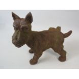 Vintage cast iron terrier with leg cocked door stop, 8 1/4" tall and 82 long.
