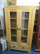 Light Oak Display cabinet with two glazed doors and two handy drawers under. Three adjustable Oak sh
